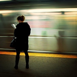 Woman reading at the station